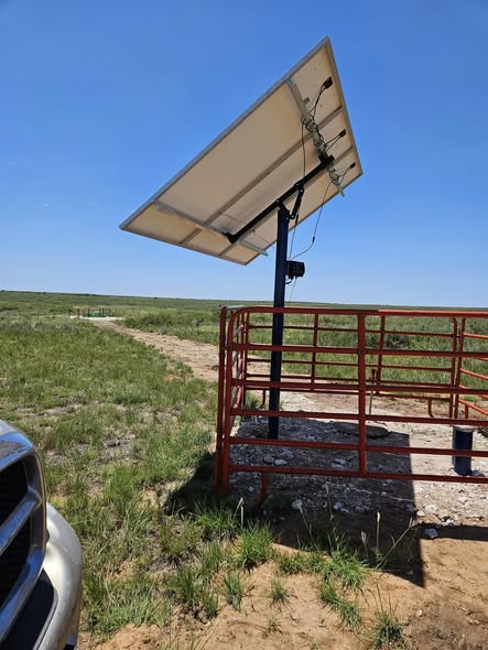 Pole-mounted solar panel powering a remote pasture well in the Texas Panhandle
